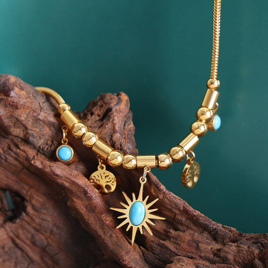 Gold and Blue stone necklace featuring a star and trees