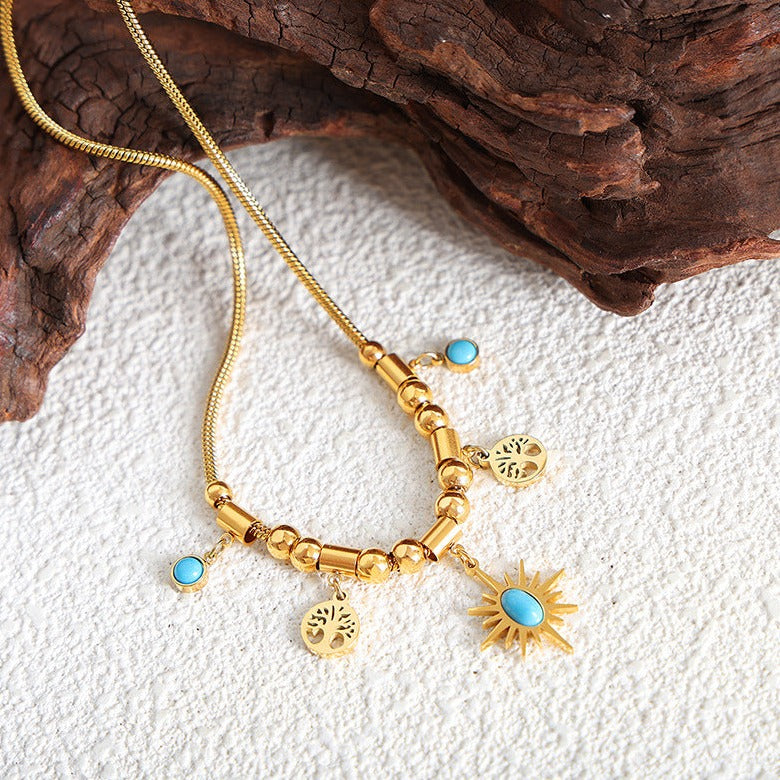 Gold and Blue stone necklace featuring a star and trees